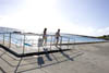 2 people standing at an outside swimmingpool