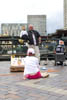 Girl listing to musician on the street