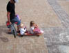 2 girls on a skateboard eating ice cream