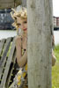 Girl standing behind a pillar